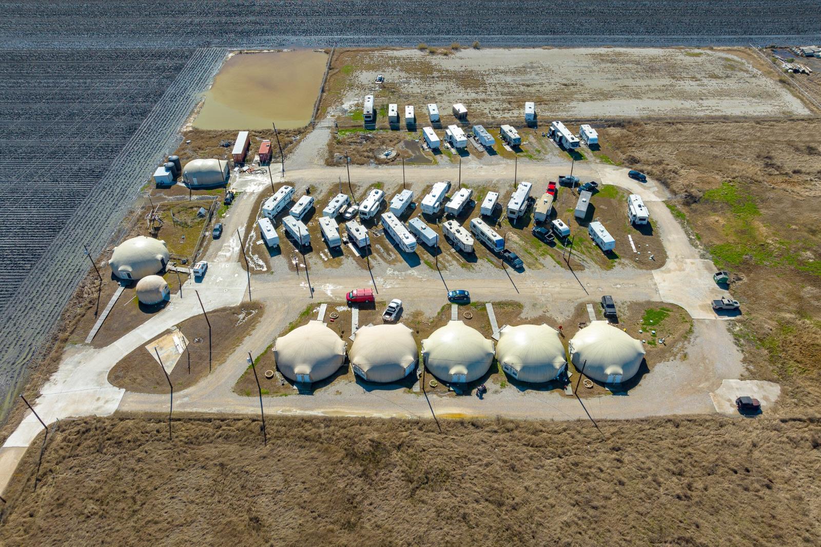 Aerial view of the domes and RV sites at The Domain Hotel RV Park & Storage in Aransas Pass, Texas