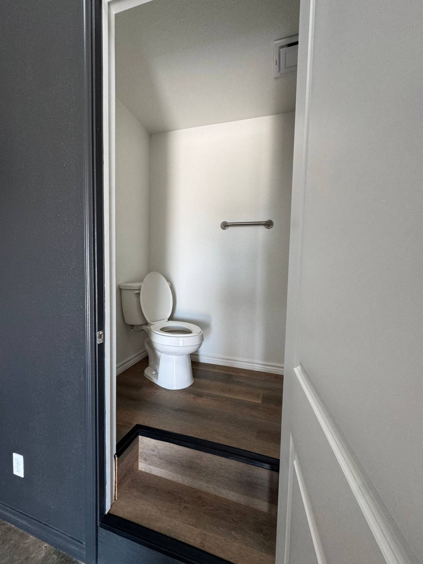 Private bathroom with grab bar in a dome unit at The Domain