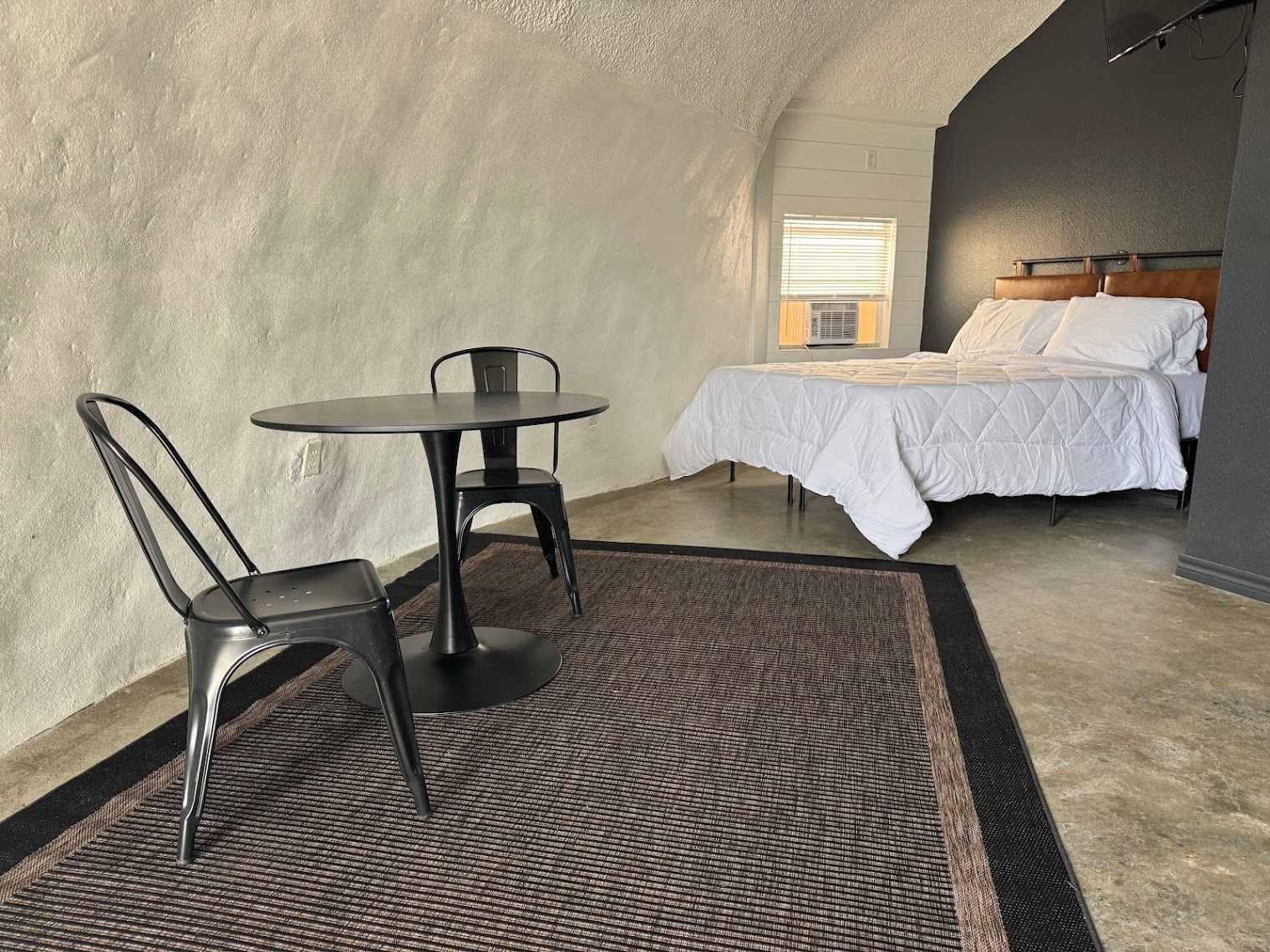 Dome room with queen bed, table and chairs at The Domain in Aransas Pass