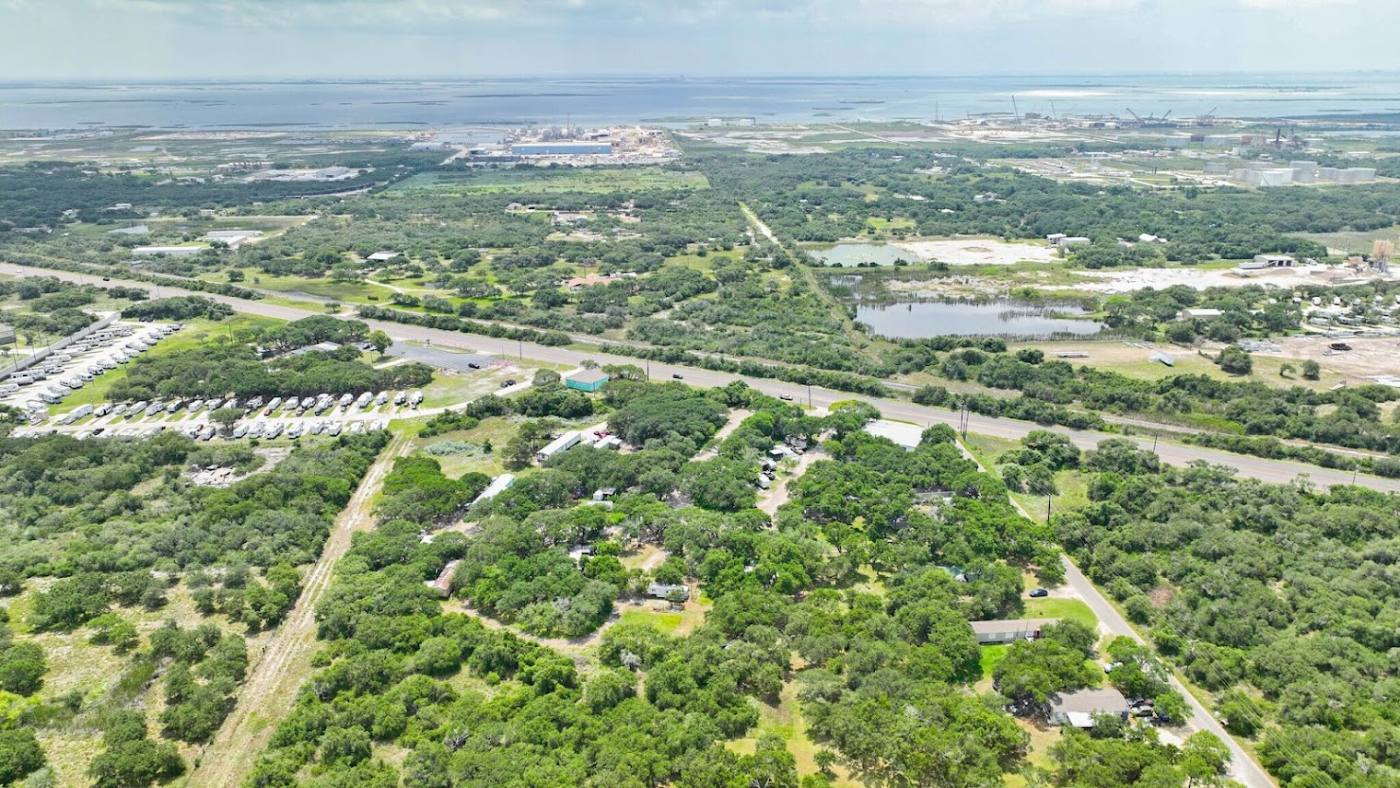 Oak-shaded sites at Indian Trails RV Park along Highway 361 near Ingleside, Texas